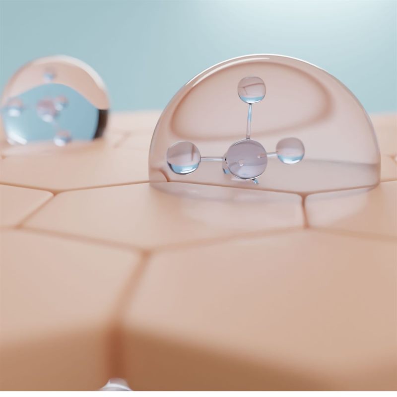 An illustration of droplets resting on a surface of skin cells, with a molecule shown inside one droplet.